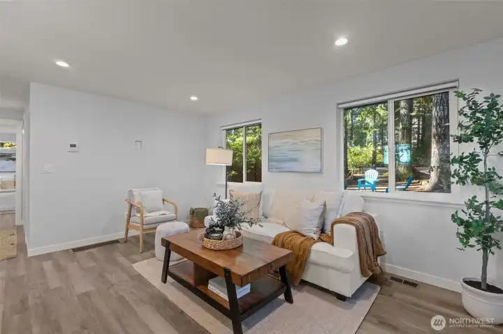 Open concept main room with eat-in kitchen bar top.