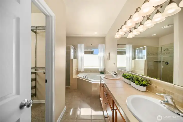 Large primary bathroom with a tub, shower, private toilet room, double sink, and spacious walk in closet!