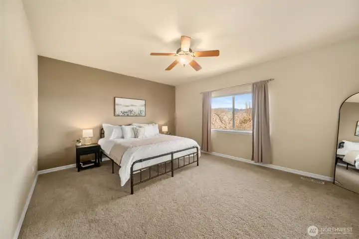 Immense primary bedroom with plenty of space to relax.