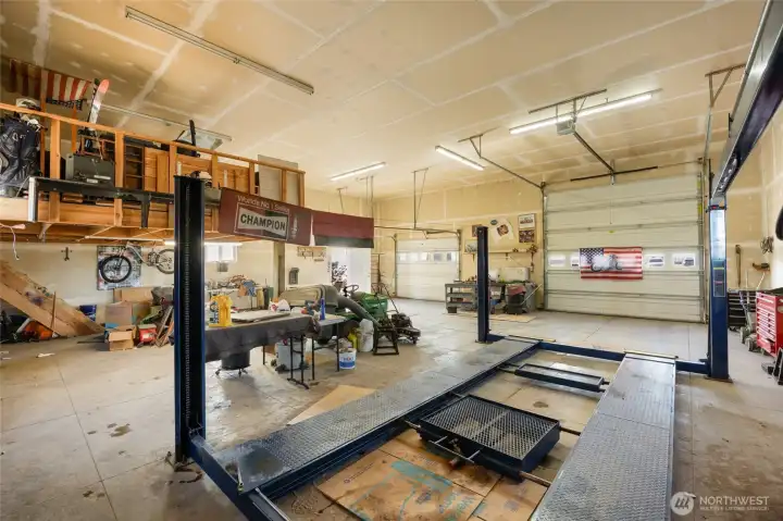 shop with car lift and upper storage area