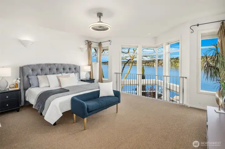The primary bedroom offers uninterrupted, picturesque views of the water