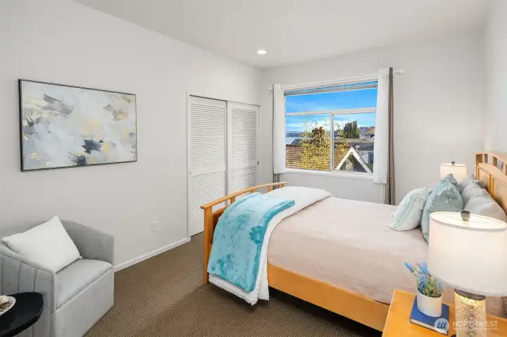 A comfortable secondary bedroom offering partial lake views
