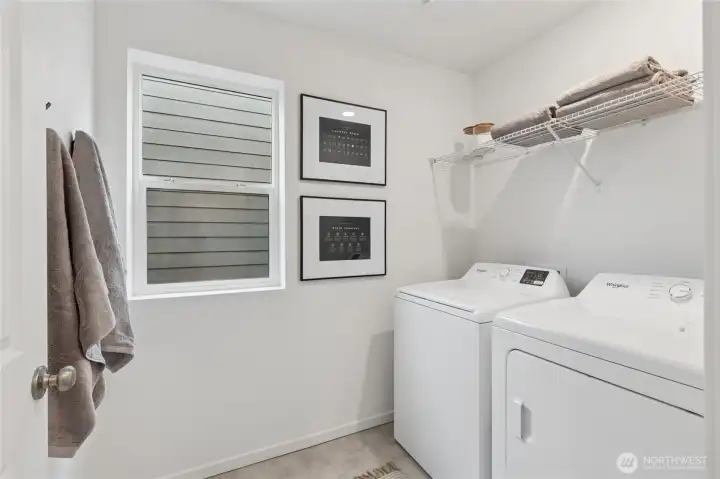 Convenient laundry area designed with functionality and good lighting.