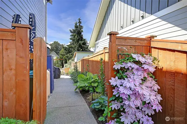 Paved walkway to your fully fenced backyard.