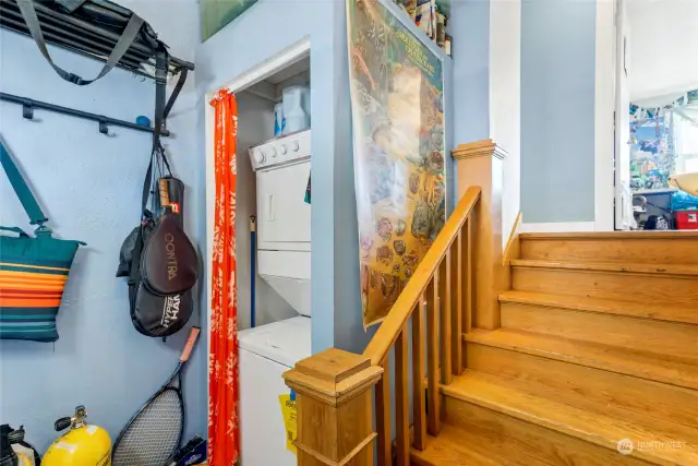 Upper upper-level unit entry opens to the landing space of original home staircase, also converted to stackable laundry space.