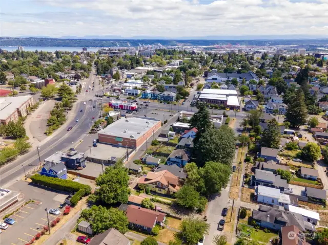 East facing Aerial view of the property and surrounding neighborhood + district. Minutes to hospitals, colleges Downtown Tacoma, Ruston Way Waterfront, & the Stadium District.