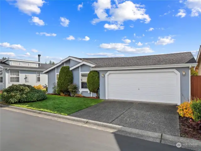 The nicely landscaped yard in the front is maintained by the condo association. Two car garage will hold your cars and tools.