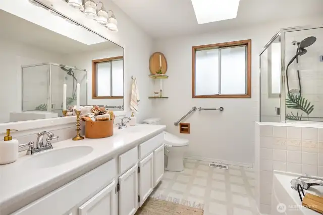 Primary suite is accompanied by a large walk-in closet with built-in storage & a 5-piece ensuite featuring a soaking tub.