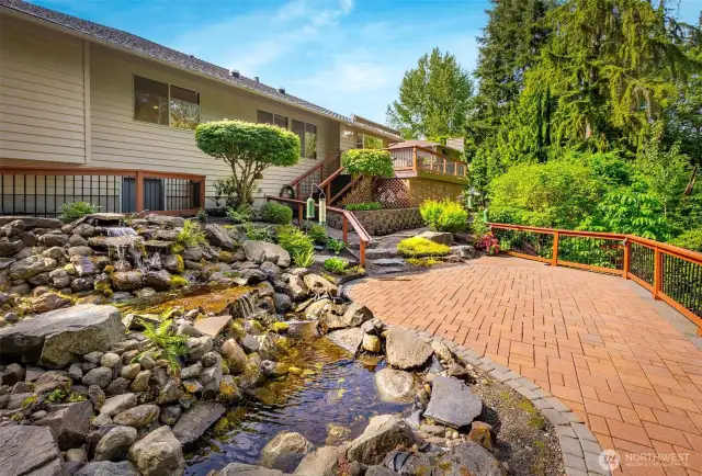 Step outside to a peaceful, park-like backyard with a generous deck, perfect for summer barbecues or relaxing  under the trees.