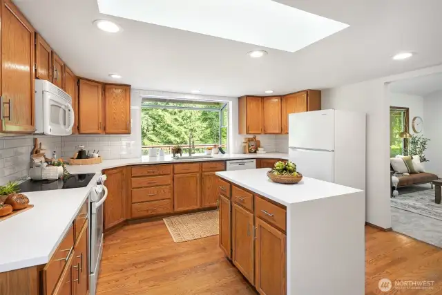 This kitchen is designed for everyday living & entertaining. Featuring updated countertops, a stylish new backsplash, fresh hardware, & an oversized pantry,