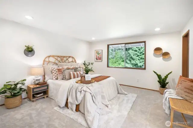 Down the hall, the spacious primary suite is a true sanctuary.