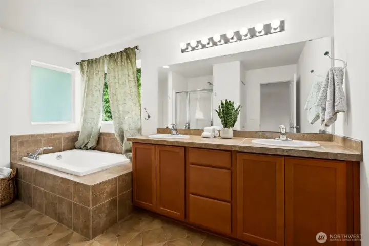 Enjoy the soaking tub in this light and bright bathroom