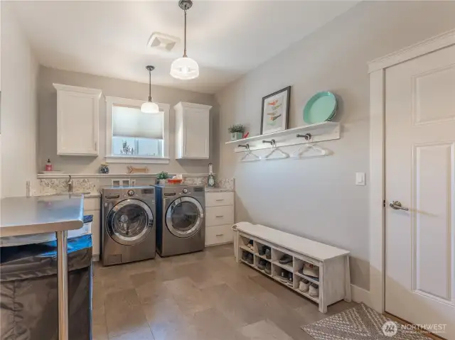 Dedicated Laundry Room – Ample storage and workspace.