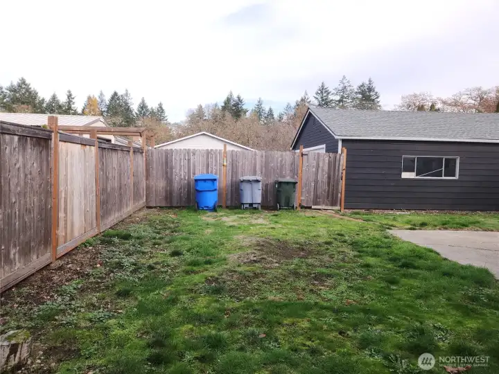 View of the fenced backyard from the shed.