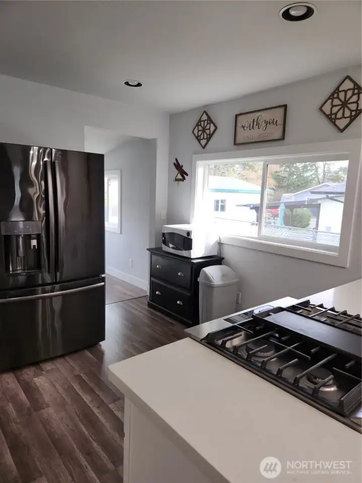 Entrance to upstairs room, the utility space and backyard off the kitchen.