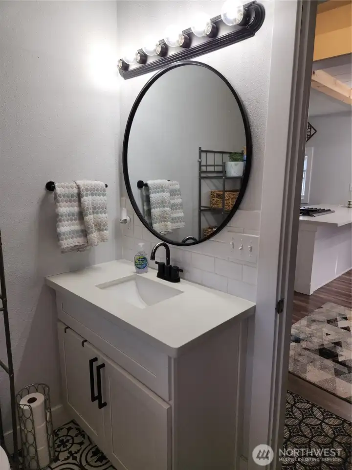 Newer vanity and granite counter tops in bathroom.