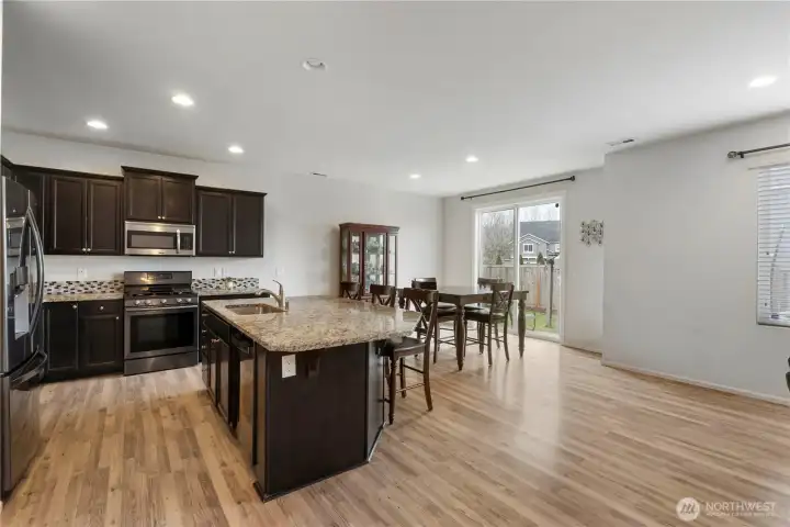 Large kitchen island provides the perfect hub for casual dining, meal prep, or hosting guests.