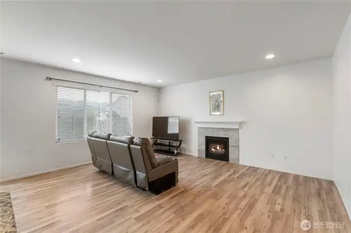 Cozy fireplace anchors the living space, creating a comfortable gathering spot year-round.