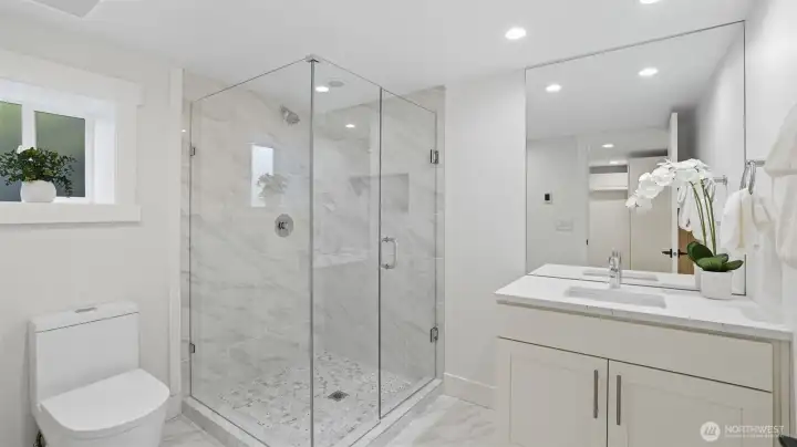 Full bathroom just off of the wine room that connects to the kitchen.