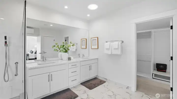 Dual sink vanity with modern finishes and heated tile floors for comfort year-round. Custom walk-in closet!