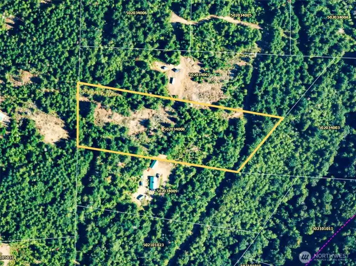 Aerial photo of the site showing the property lines. Road access at w & E of the property.