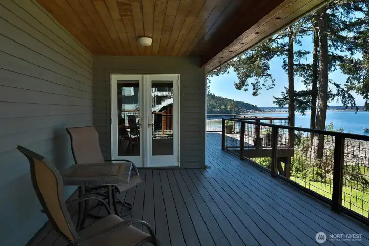 Covered portion of your deck with French doors that lead to the dining area. There are two other sets of French doors that lead from the dining area to the front (uncovered) deck and from the living room to the front deck.