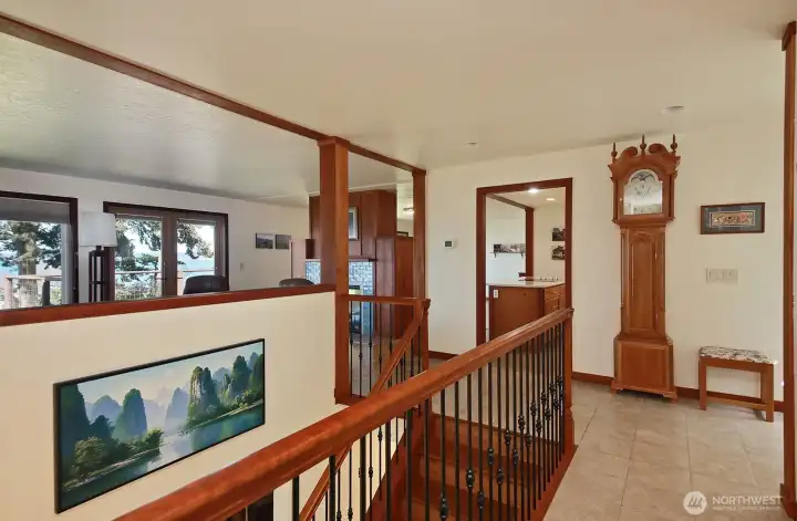 Standing in the hallway looking back at the foyer, kitchen is through the open doorway to the left of the grandfather clock. Office is just beyond the right edge of this photo.