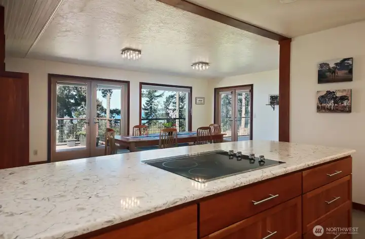 Did we mention that you can see the water from almost every room? Here's your view from your Kitchen into the Dining Area. Note the two sets of French doors that take you to your deck.