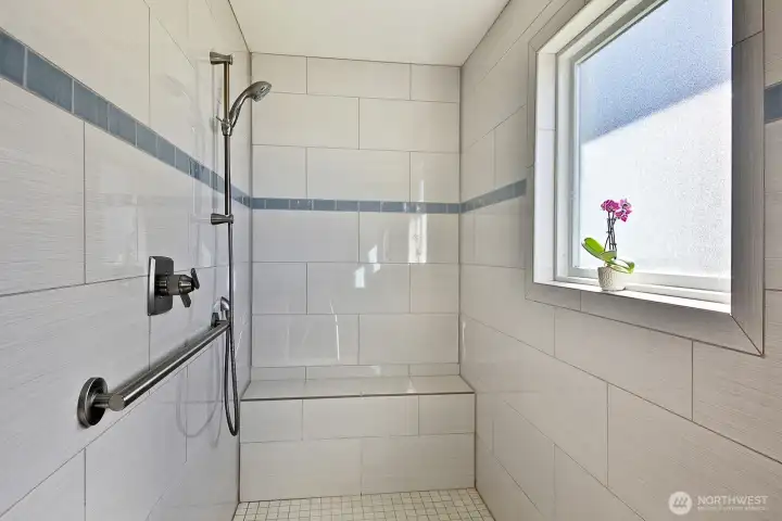 Custom tiled zero threshold shower. With a generous window, of course!