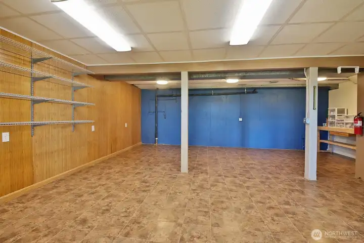 Now looking in the opposite direction (water view to your back). Huge space! Would make an excellent   Rec Room! There is a second door to this room just beyond the right edge of this photo that leads to a hallway with utility room (furnace & water heater), and additional closet space.