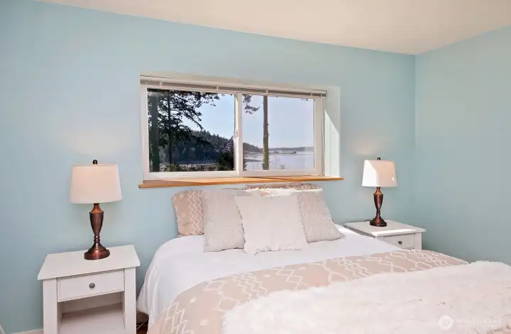 One of two lower level bedrooms. There is a closet to your back and a view here, too!