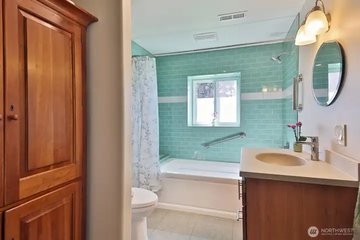 Full bath with a heated soaking tub. Armoire to the left conveys.