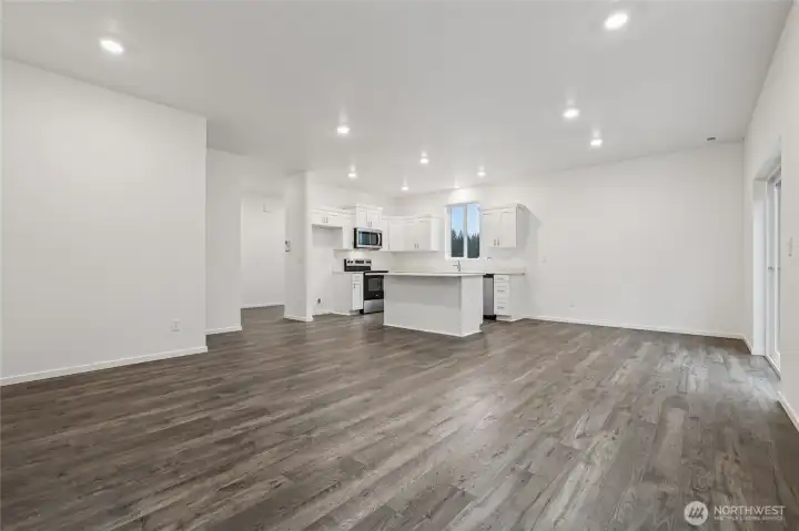 Kitchen open to dining and living area.   Pictures are for representational purposes only, colors and features may vary.