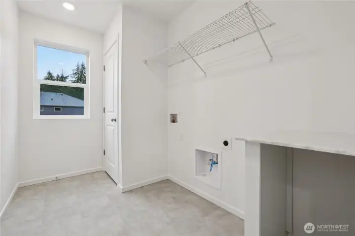 Laundry room upstairs with window.   Pictures are for representational purposes only, colors and features may vary.