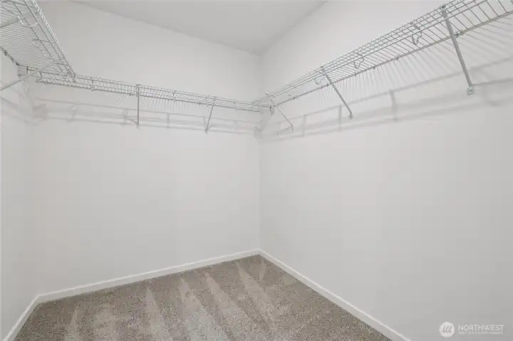 Primary closet off of primary bathroom.   Pictures are for representational purposes only, colors and features may vary.