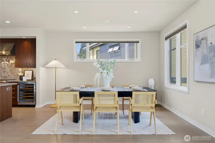 Generous, light-filled dining with room for eight and a built-in wine fridge steps from the kitchen — effortless entertaining by design.