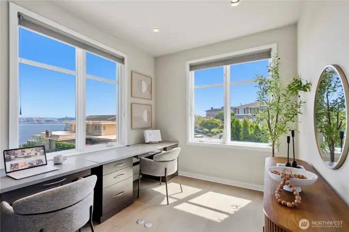 Work from home has never looked like this — a corner study with dual water-view windows and a built-in double desk facing the Sound.
