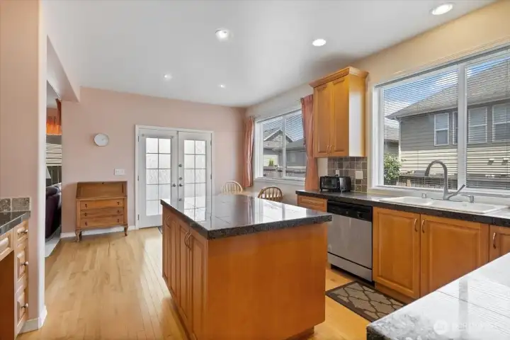 Kitchen opens to separate eating space opening into Family room