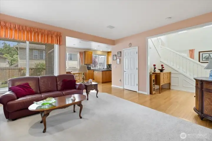 Family room looking to staircase and kitchen