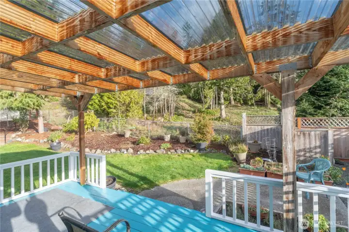 The yard has well-established plantings for your enjoyment. There is a small fenced storage area too.