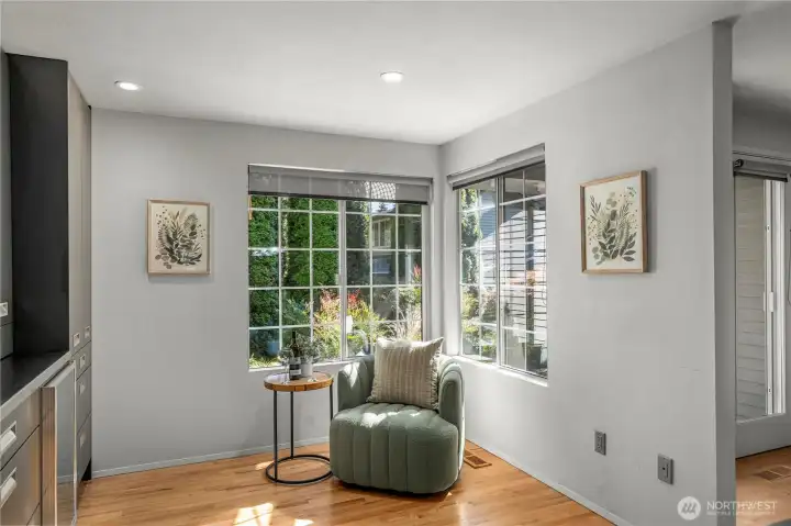 Sunlit breakfast nook surrounded by oversized windows