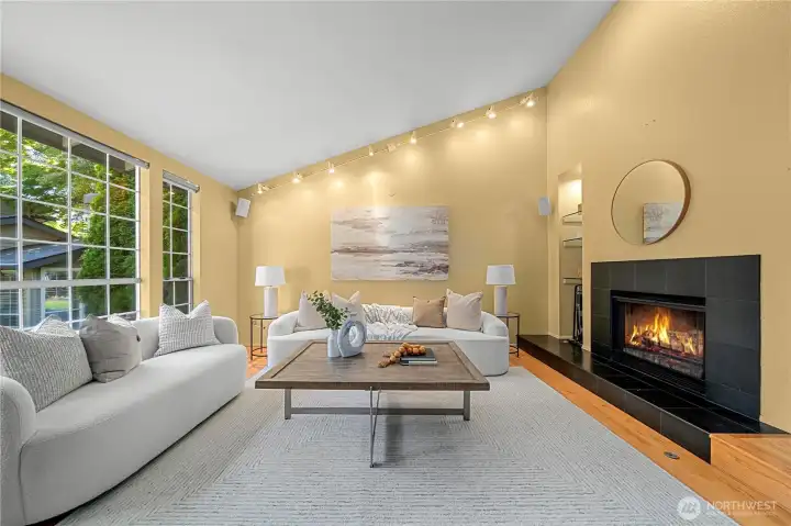 A stunning great room with soaring vaulted ceilings and expansive windows creates an impressive sense of space and light.