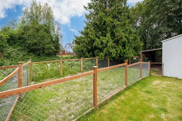 Separately fenced area convenient for gardening, pets, and storage.