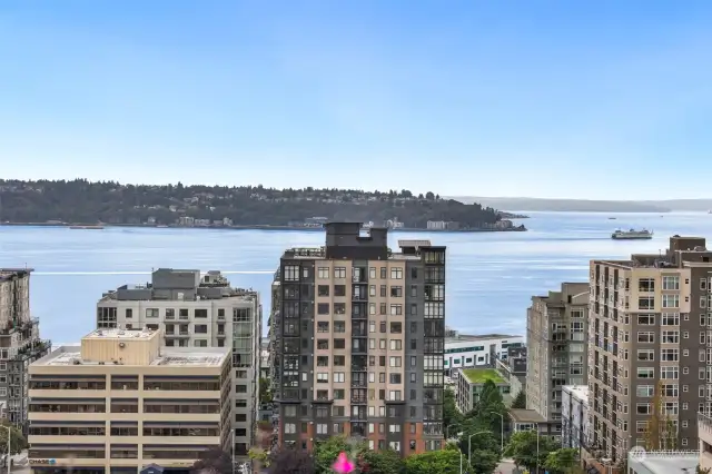 The rooftop offers breathtaking views of the Puget Sound, where ferries cross the water, and sunsets light up the horizon.