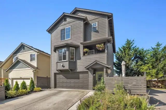 View of the front of the townhome, nestled into the end of a cul-de-sac street for peace and privacy.