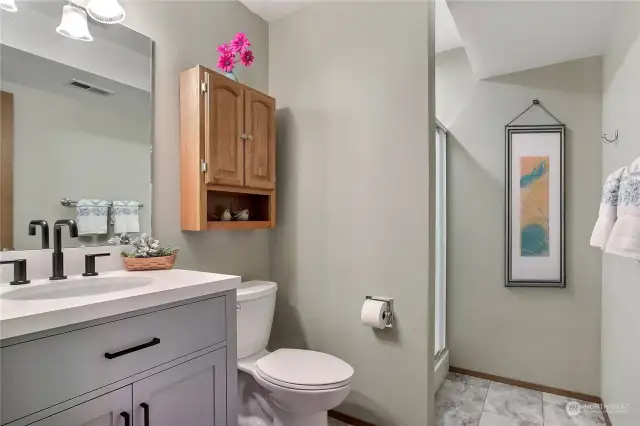 Lower level 3/4 bath. Digitally staged.