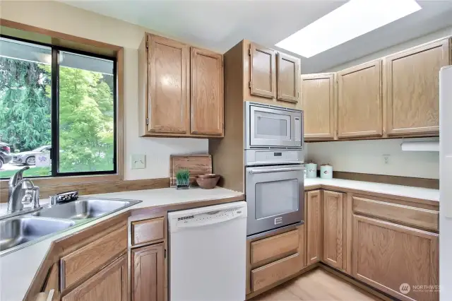 A bright eat-in kitchen offers a double oven, large pantry, corner window and deck slider.