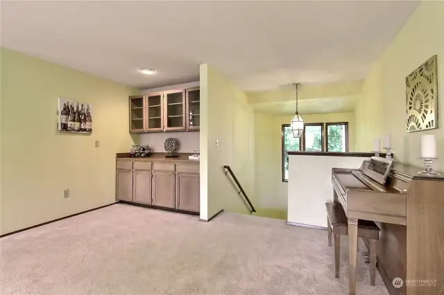 generous living room with cozy gas fireplace and built-in cabinets.