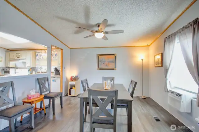 Here is a view of the dining area looking into the kitchen. There is a pony wall pass-through separating the dining area and kitchen.