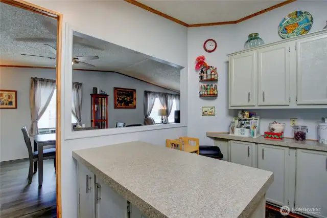 Attached kitchen island with open pass thru to dining.